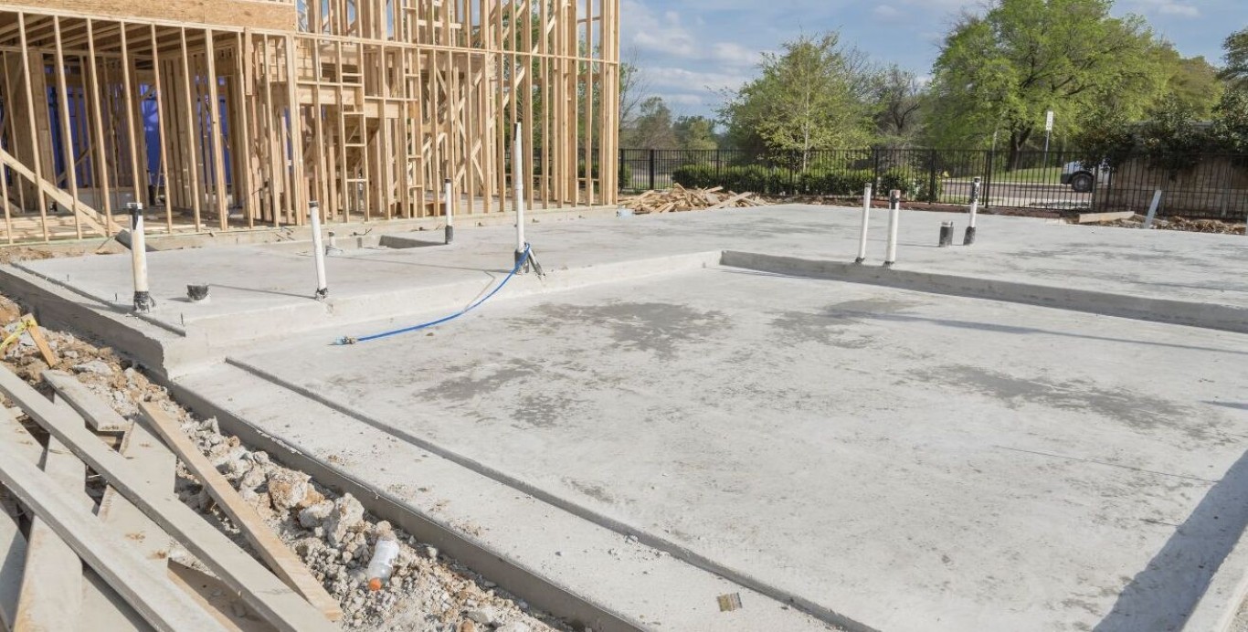 New residential concrete slab and foundation poured for house construction