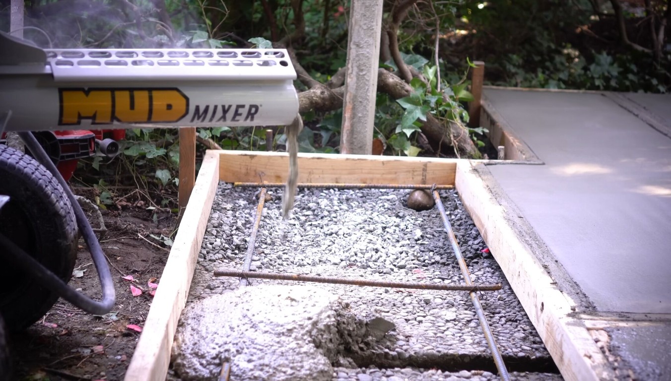 Concrete walkway and sidewalk installation in progress with rebar and gravel base